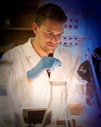 Jarius Pulczinski in a lab with beakers in the foreground